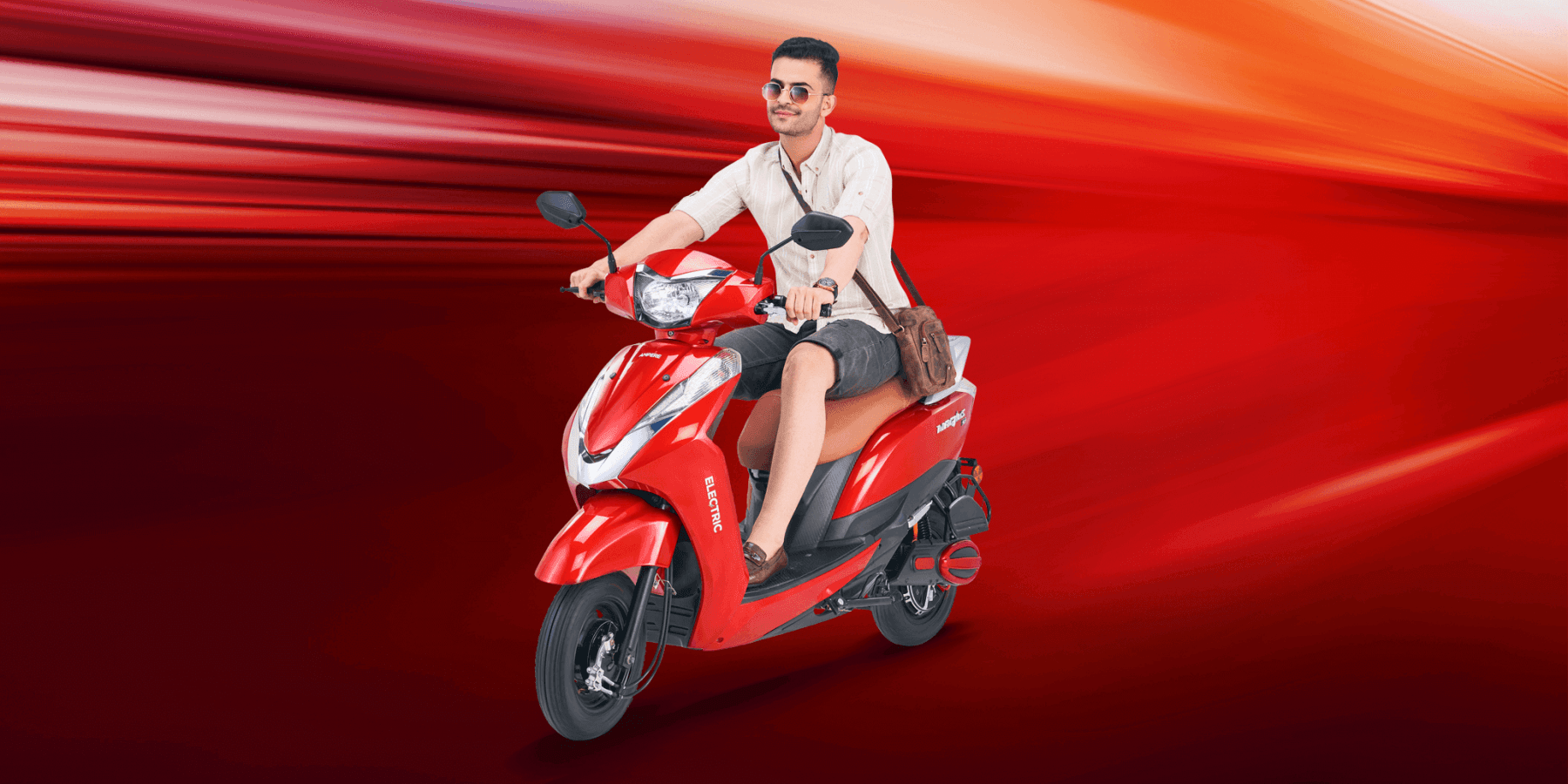 A man is driving a Red Ampere Magnus Ex Scooter with comfort.